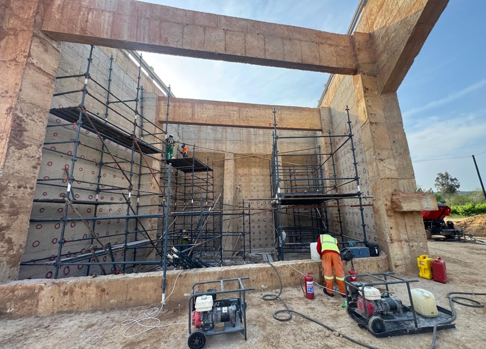 Installing steel to reinforce bridge abutment