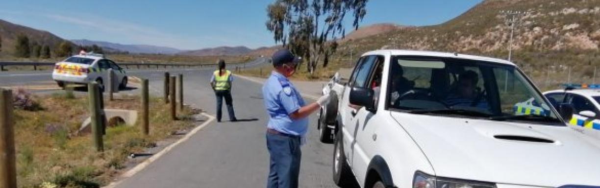 Traffic officer at a roadblock issuing a fine