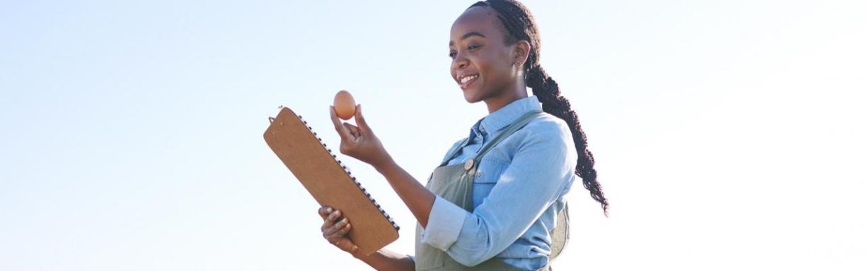 Woman in field with egg