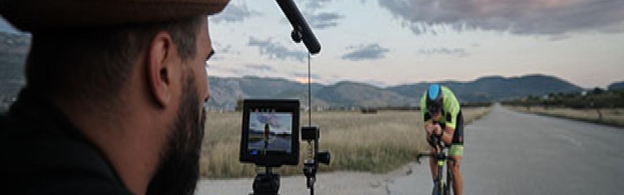 Cameraman filming a cyclist