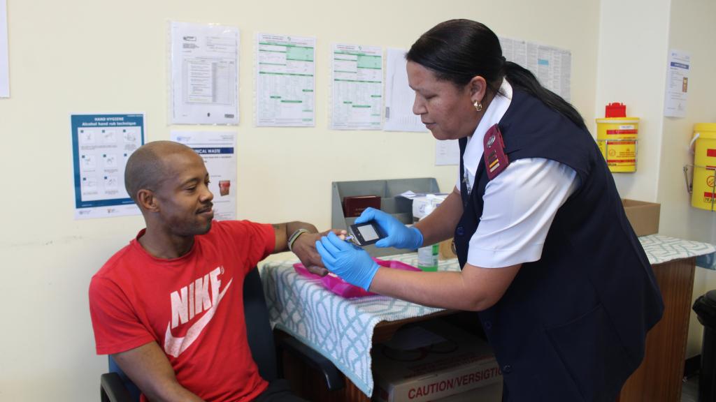 Tygerberg Hospital patient, Angelo Plaatjies’s blood sugar level is administered by Professional Nurse Francis Pietersen.