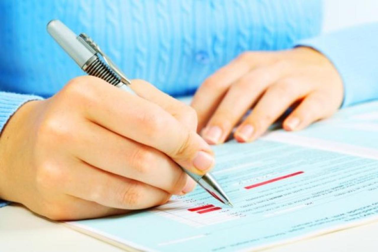 Hands of a person completing a form