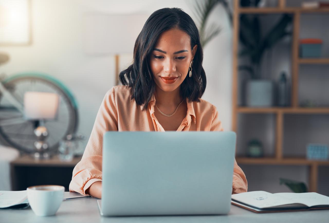 Young woman sitting looking at her laptop