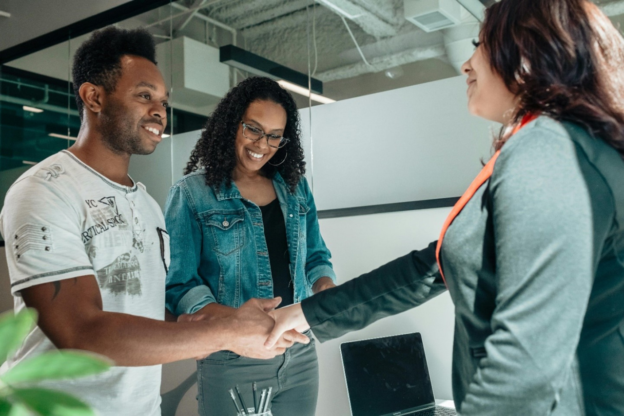 Lady shaking hands with a man