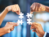 Hands holding puzzles that fit