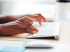 Person typing on keyboard