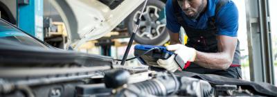 A mechanic testing a vehicle's roadworthiness