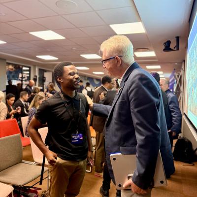Premier Winde engaging with an attendee at the Premier's Council on Skills